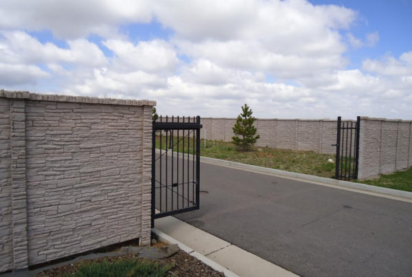Concrete fence with black moving gate